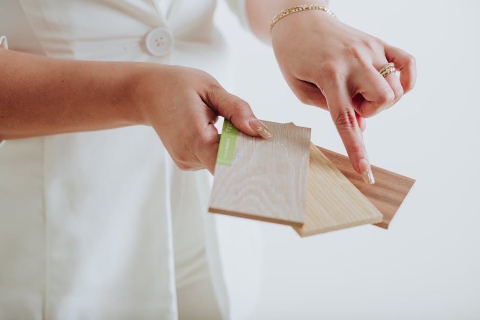A woman points to different wood samples, highlighting interior design choices.