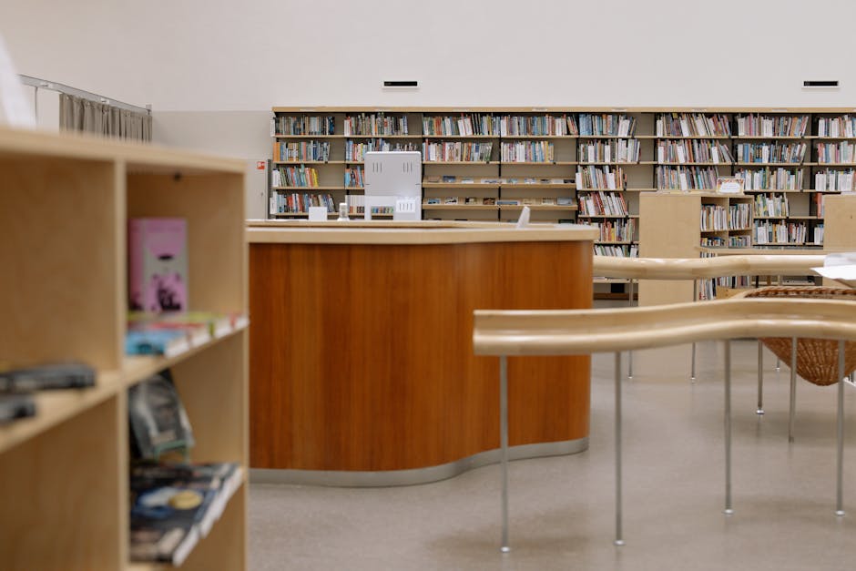 Contemporary university library with wooden furniture and extensive book collection.